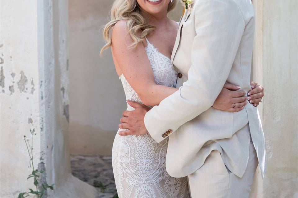 a wedding couple embracing in greece