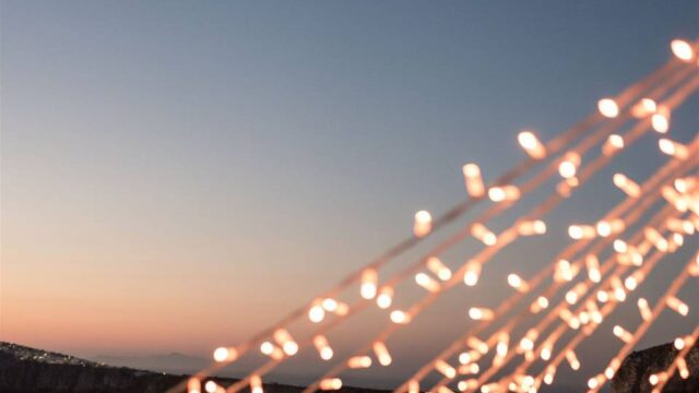 string lights with sea backdrop at a greek wedding