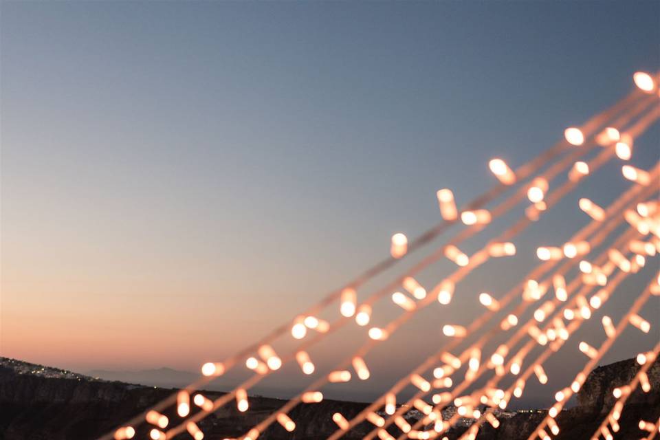 string lights with sea backdrop at a greek wedding