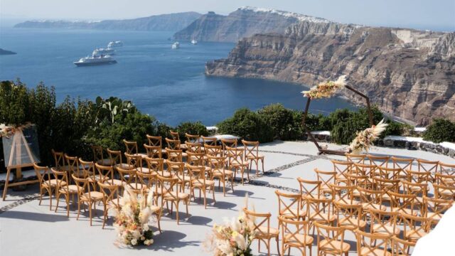 chairs set for a wedding ceremony overlooking the sea in santorini