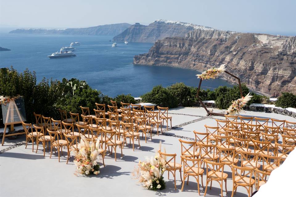 chairs set for a wedding ceremony overlooking the sea in santorini