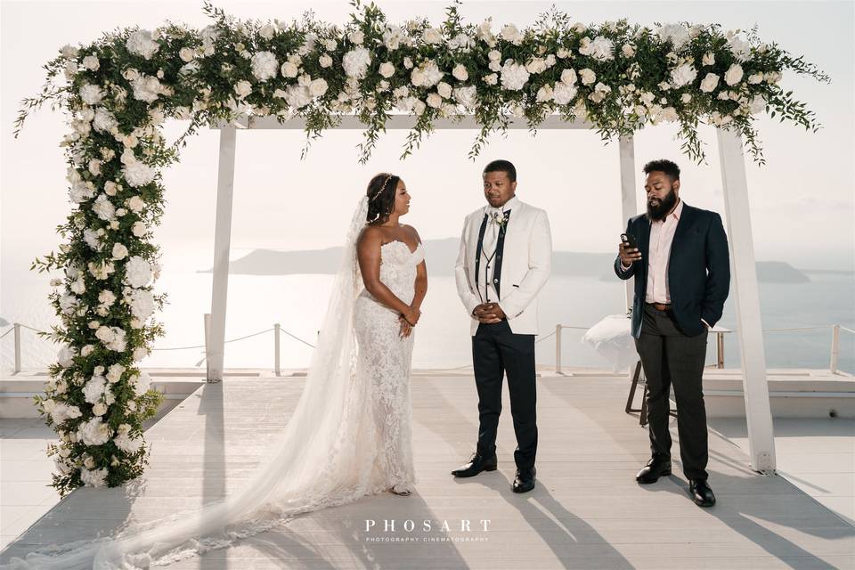 a wedding couple at a wedding ceremenoy in santorini
