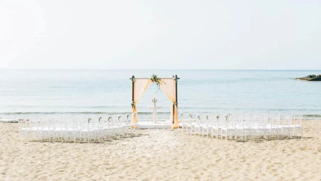a beautifully set beach wedding in crete with the aegean sea in the background