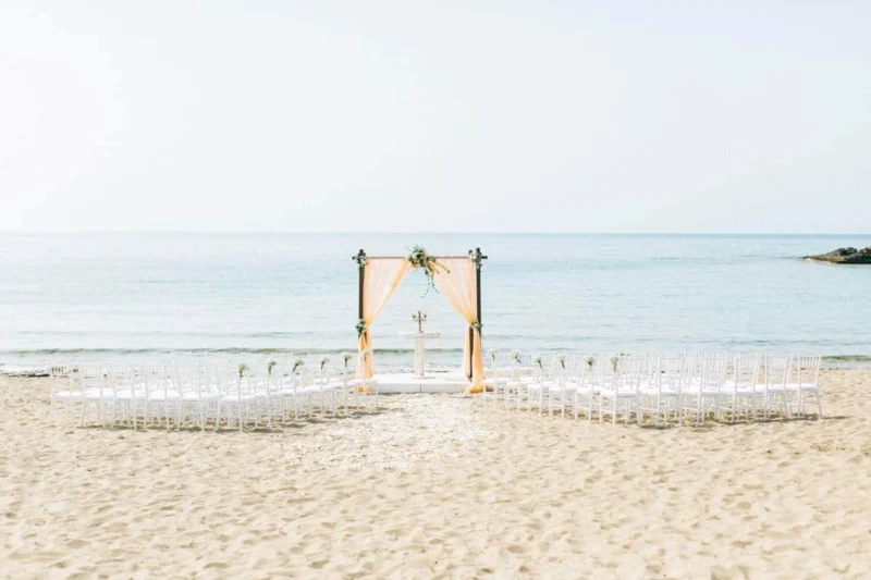 a beautifully set beach wedding in crete with the aegean sea in the background