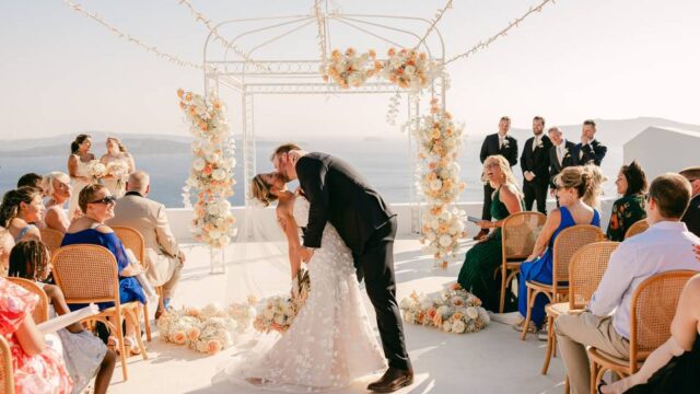 a couple kissing at their santorini wedding