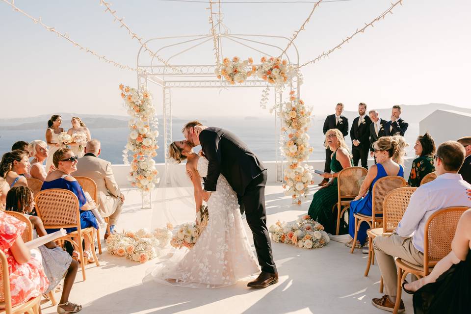 a couple kissing at their santorini wedding