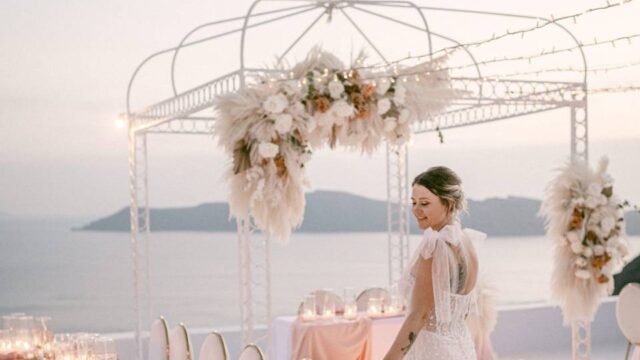 a bride admiring the tables at her santorini wedding