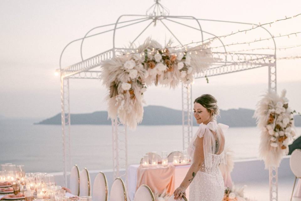 a bride admiring the tables at her santorini wedding