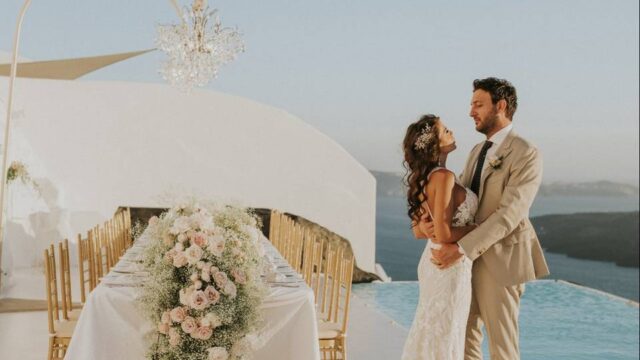 a wedding couple looking into each others eyes at their greek wedding