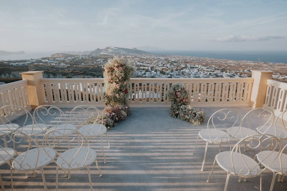 a wedding ceremony setup for a santorini wedding
