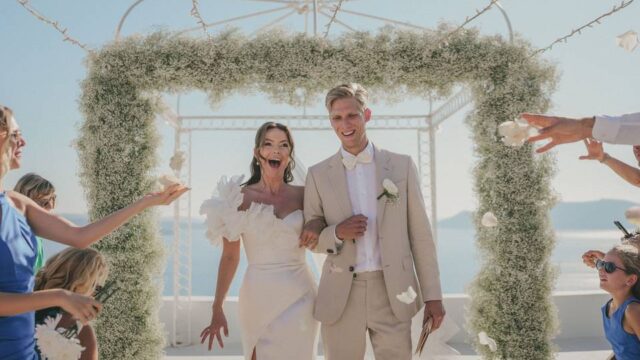 bride and groom walking down the aisle at their wedding in greece