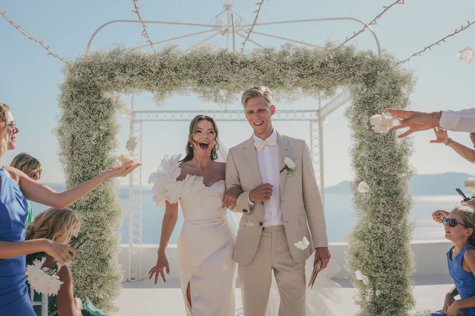 bride and groom walking down the aisle at their wedding in greece