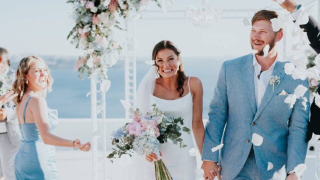 bride and groom walking down the aisle holding hands