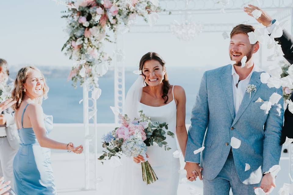 bride and groom walking down the aisle holding hands