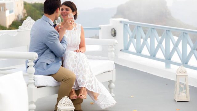 a wedding couple in santorini posing and laughing