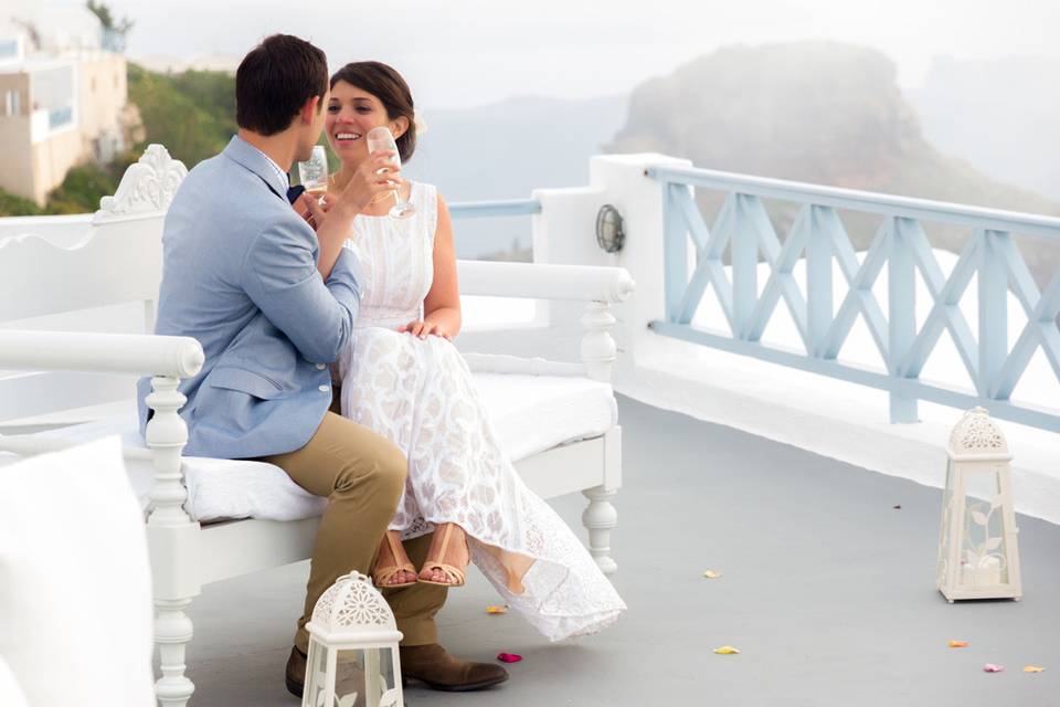 a wedding couple in santorini posing and laughing