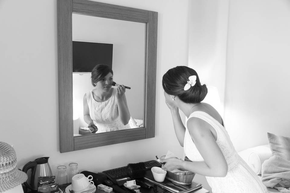 a greek bride putting on makeup