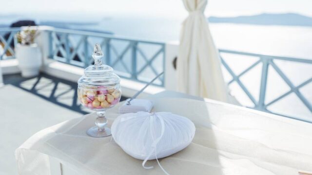 a heartshaped pillow and treats at a santorini wedding