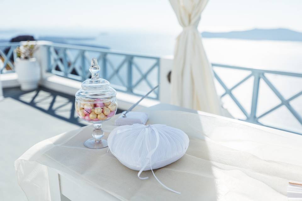 a heartshaped pillow and treats at a santorini wedding