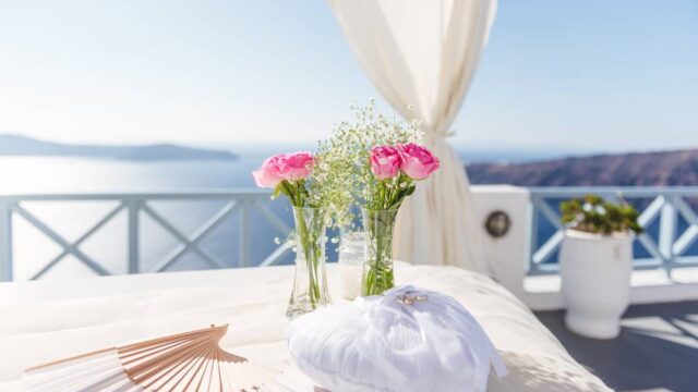 flowers and a fan at a santorini wedding