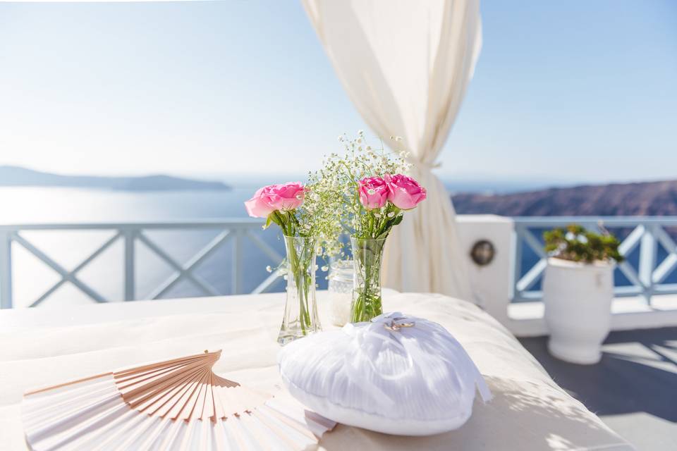 flowers and a fan at a santorini wedding