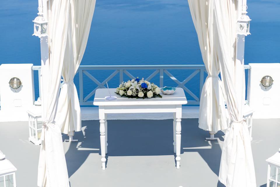 a ceremony table setup for a wedding in greece