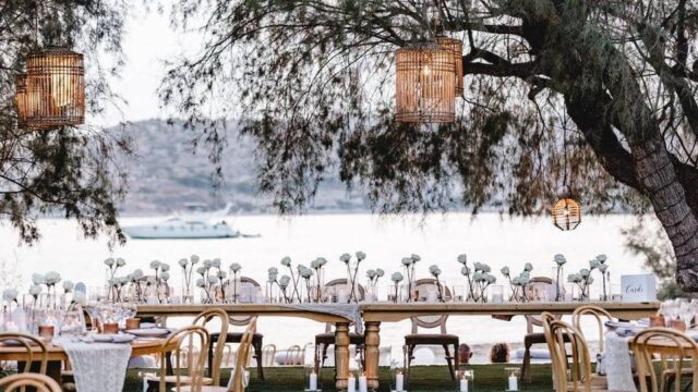 a beautifully set greek wedding table with lanterns