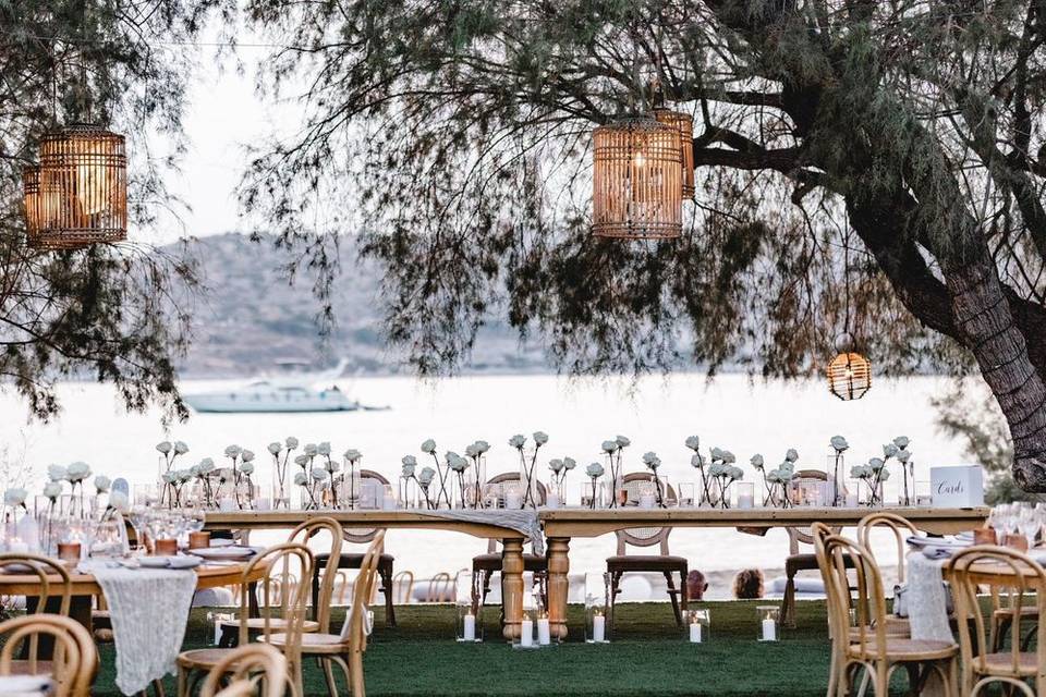 a beautifully set greek wedding table with lanterns