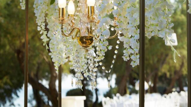 a chandelier with flowers at a greek wedding