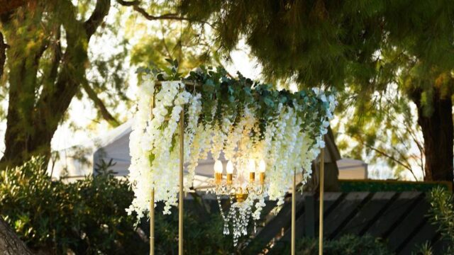 a chandelier and flowers beautifully draping for a greek wedding