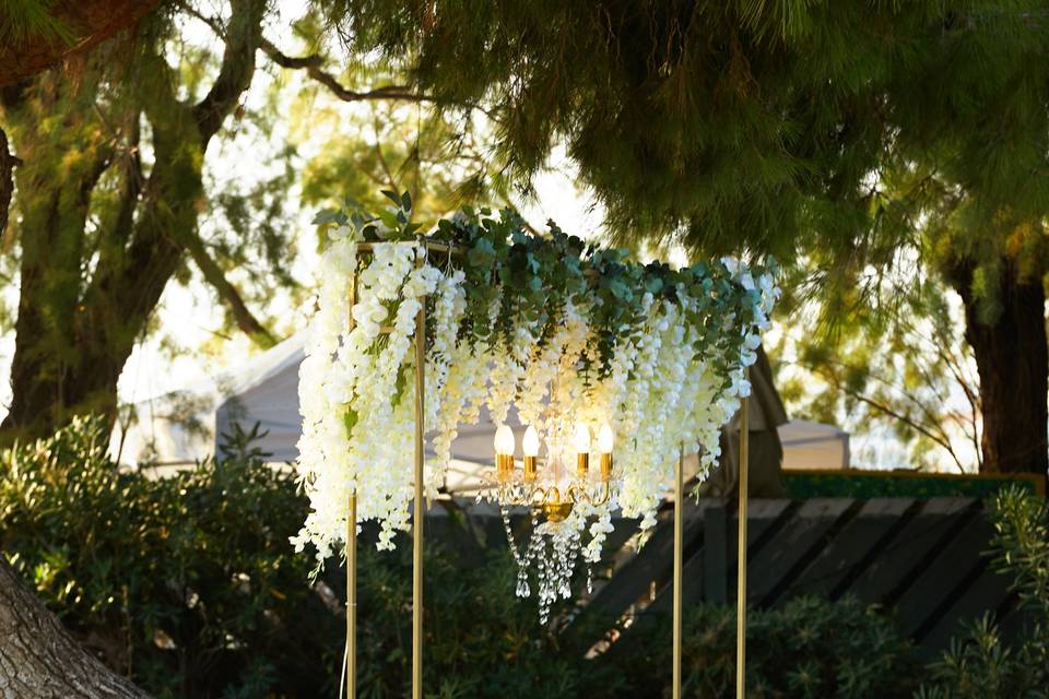 a chandelier and flowers beautifully draping for a greek wedding