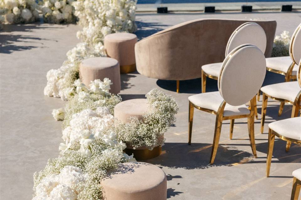 white flowers and chairs in santorini