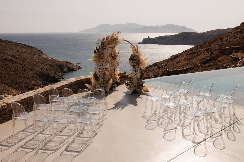 imposing view of a wedding arch overlooking the santorini caldera