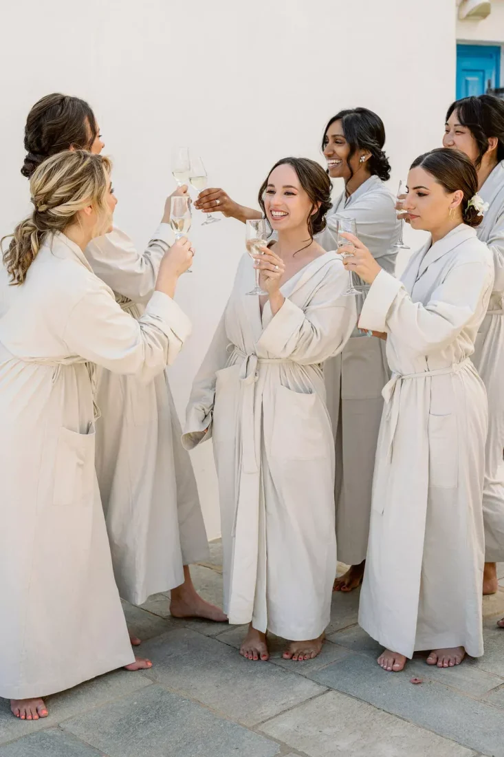 women socializing as they get ready for a greek wedding