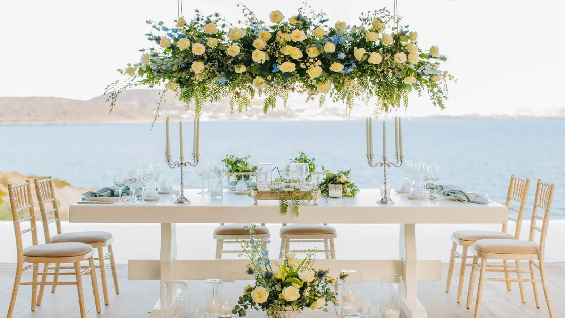 a wedding table set with a view over the greek aegean sea