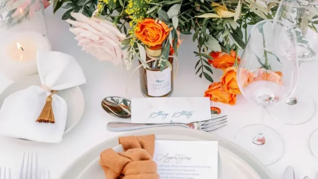 a complementary wedding table color scheme with orange, yellow, white, and coral colors