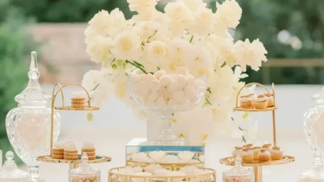 white flowers and delicacies set on a table for a greek wedding
