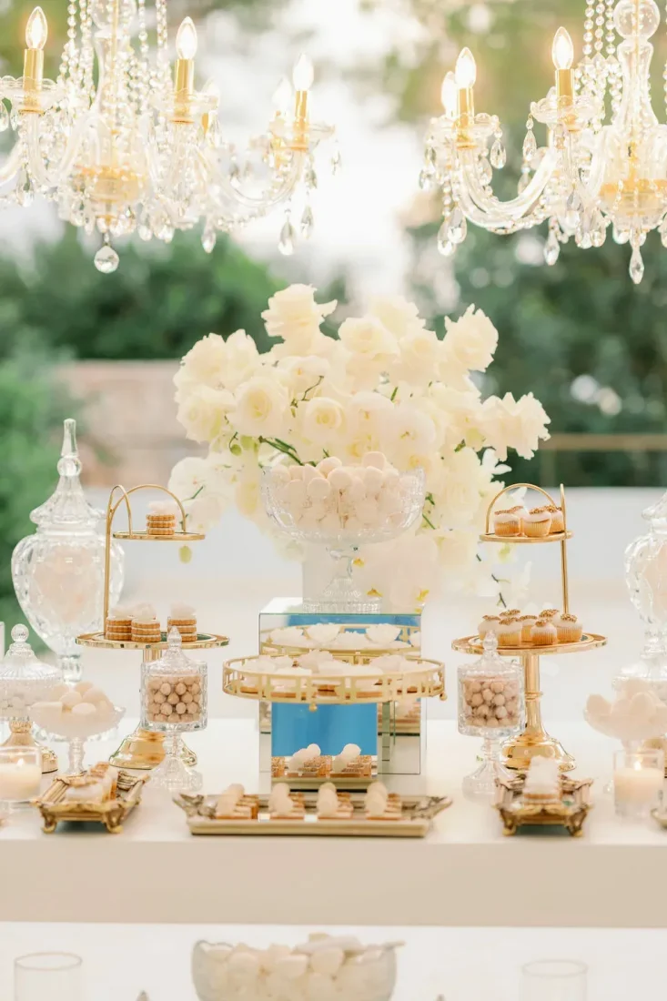 white flowers and delicacies set on a table for a greek wedding