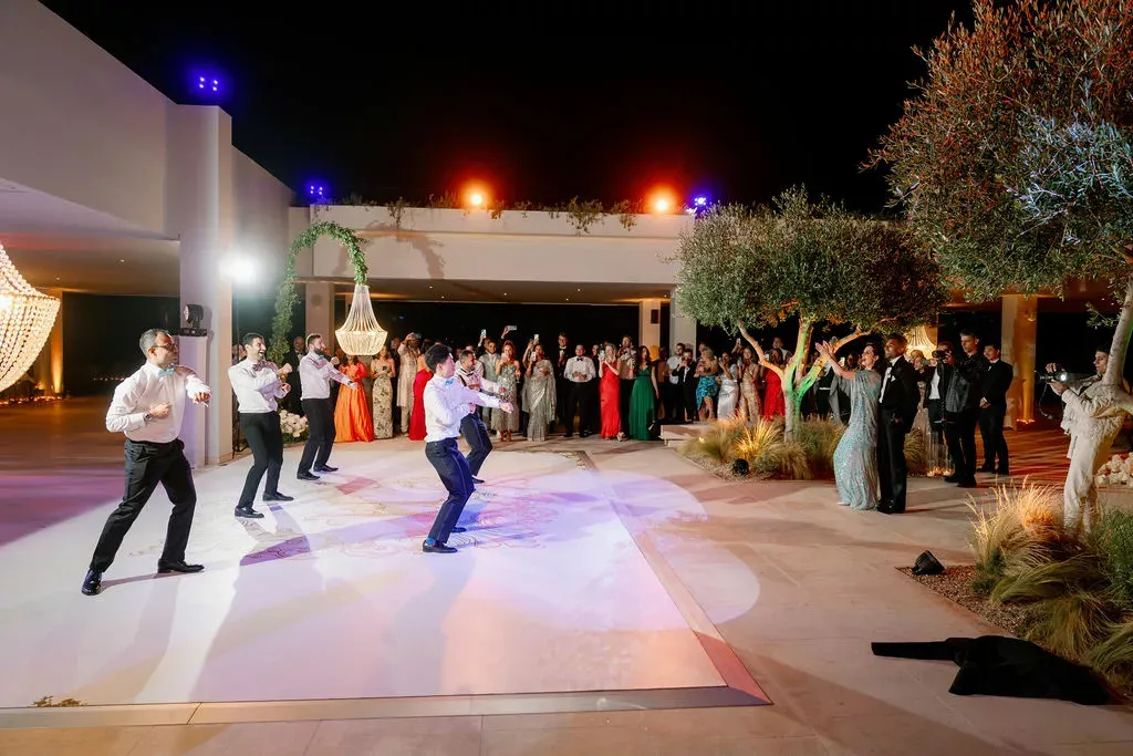people dancing at a greek wedding reception