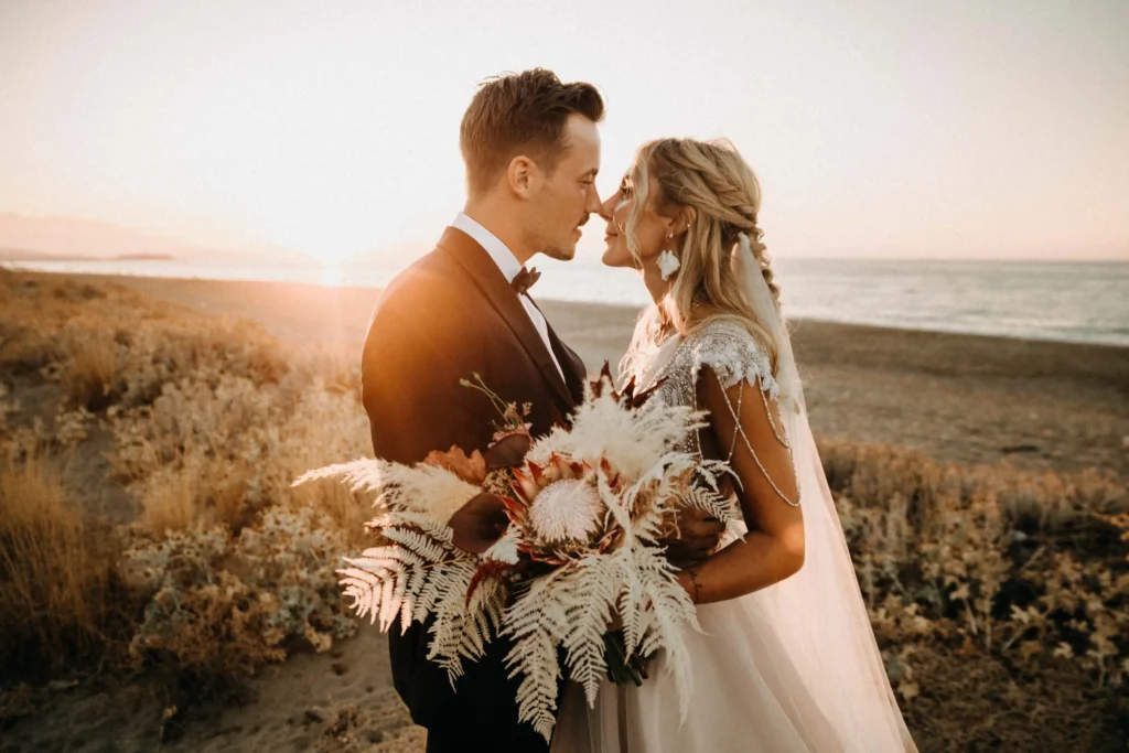 intimate wedding of a couple eloping in greece crete standing on the beach