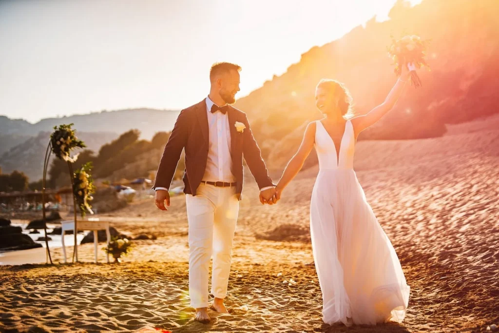an eloping newlywed couple holding hand on a greek island