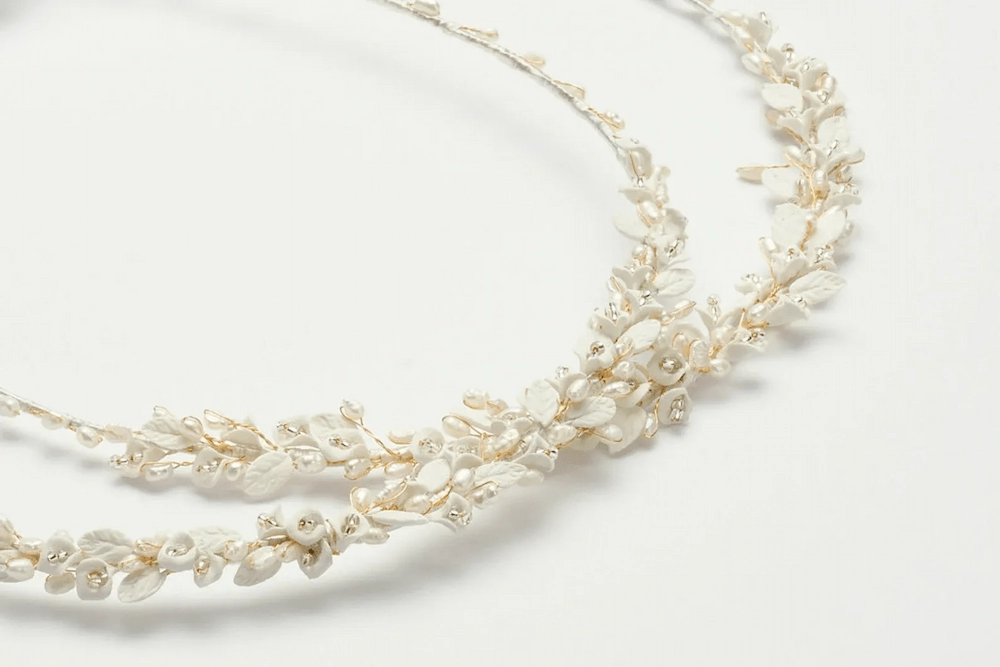 Close-up of Greek wedding stefana made with porcelain flowers, freshwater pearls and crystals