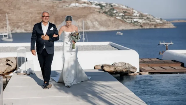 kalesma mykonos bride walking down the aisle with her father at a greek wedding in mykonos