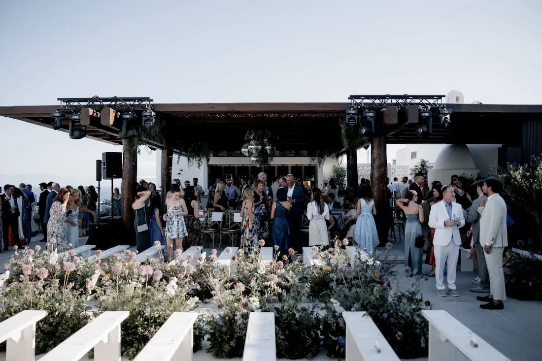 kalesma mykonos guests getting ready to sit down for wedding service