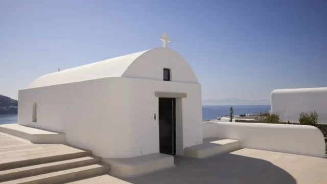 a white-washed cycladic style wedding chapel at kalesma mykonos in greece