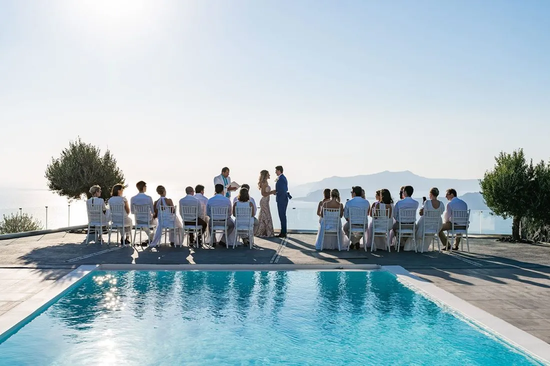 thermes villa and spa private wedding villa in santorini with a couple getting married near the pool