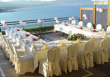 wedding table and flower decoration setup with the sea behind at the Lindos Mare, Seaside Hotel in Rhodes