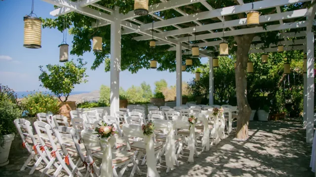 chairs under a pergolas Melenos Art Boutique Hotel setup for a wedding in rhodes