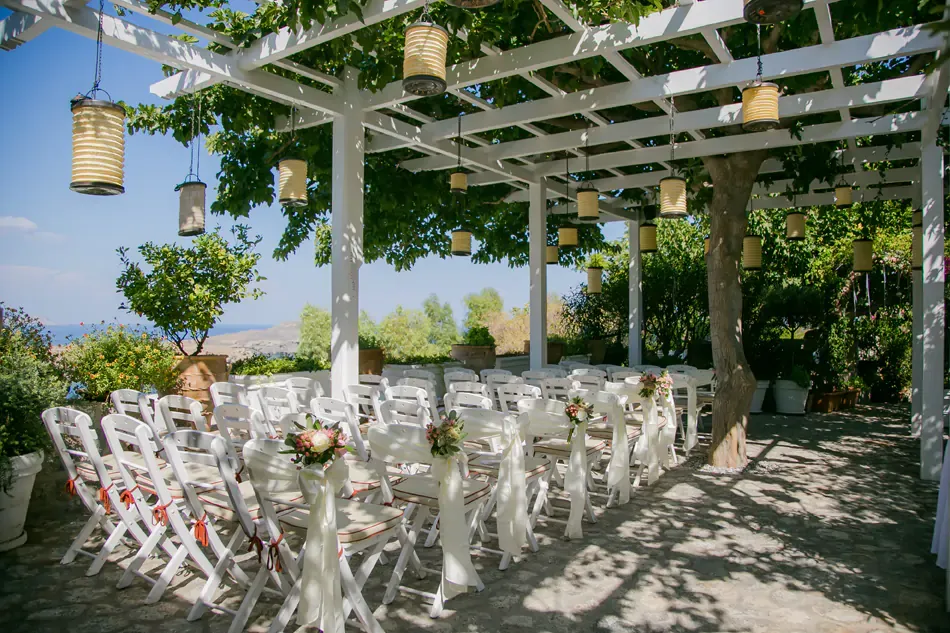 chairs under a pergolas Melenos Art Boutique Hotel setup for a wedding in rhodes