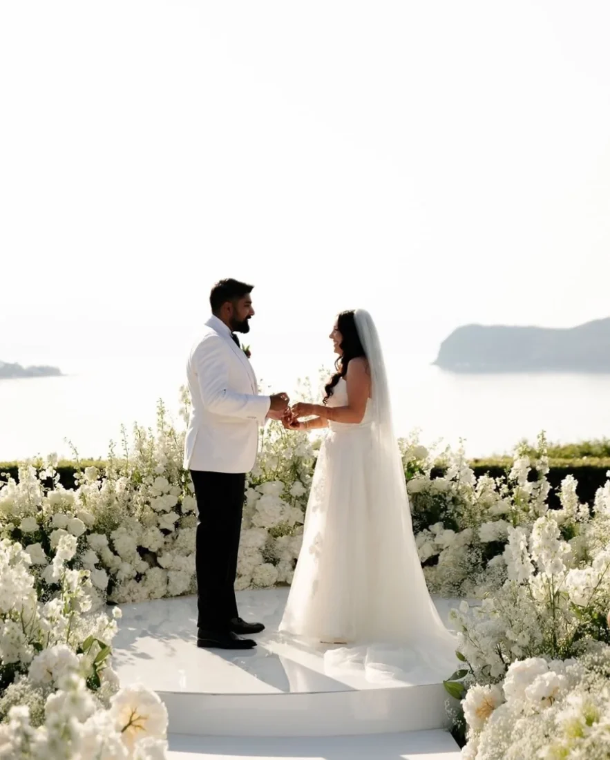 a bride and groom exchanging vows in front of the agean sea in crete